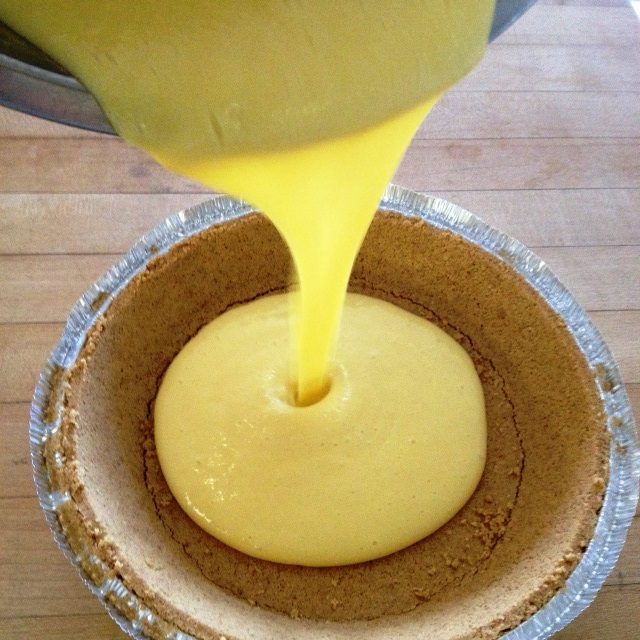 pouring key lime pie batter into crust